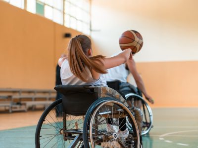 a young woman playing wheelchair basketball in a professional team. Gender equality, the concept of sports with disabilities. . High quality photo.Selective focus